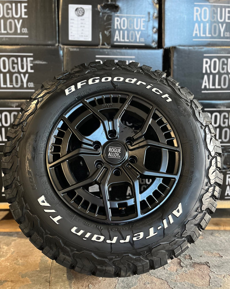 A Rogue Alloy wheel and BFGoodrich All-Terrain tyre in front of stacked Rogue Alloy boxes, ready for collection