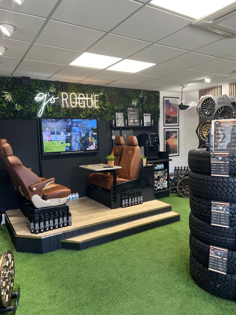 The Rogue showroom: the seating area, a stack of tyres and the go Rogue neon sign