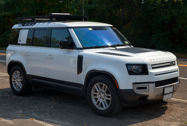 Front three-quarter view of a 2021 Land Rover Defender 110 L663 on factory wheels