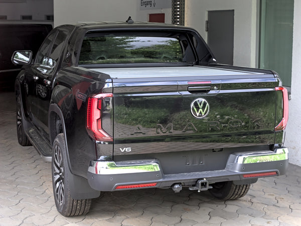 Rear three-quarter view of a Volkswagen Amarok Mk2 V6 on factory wheels, photographed in 2023